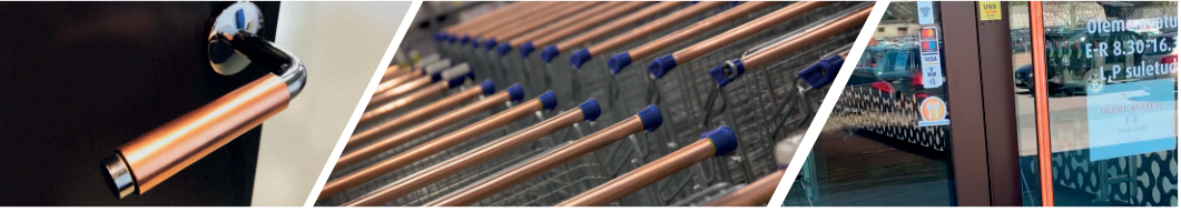 Copper Shield surface coverings on a door handle, shopping cart handles, and a shop entrance